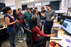 DAC Assistant Professors Dhruv Batra and Devi Parikh discuss their Visual Question Answering (VQA) project with students from thier Computer Vision Lab